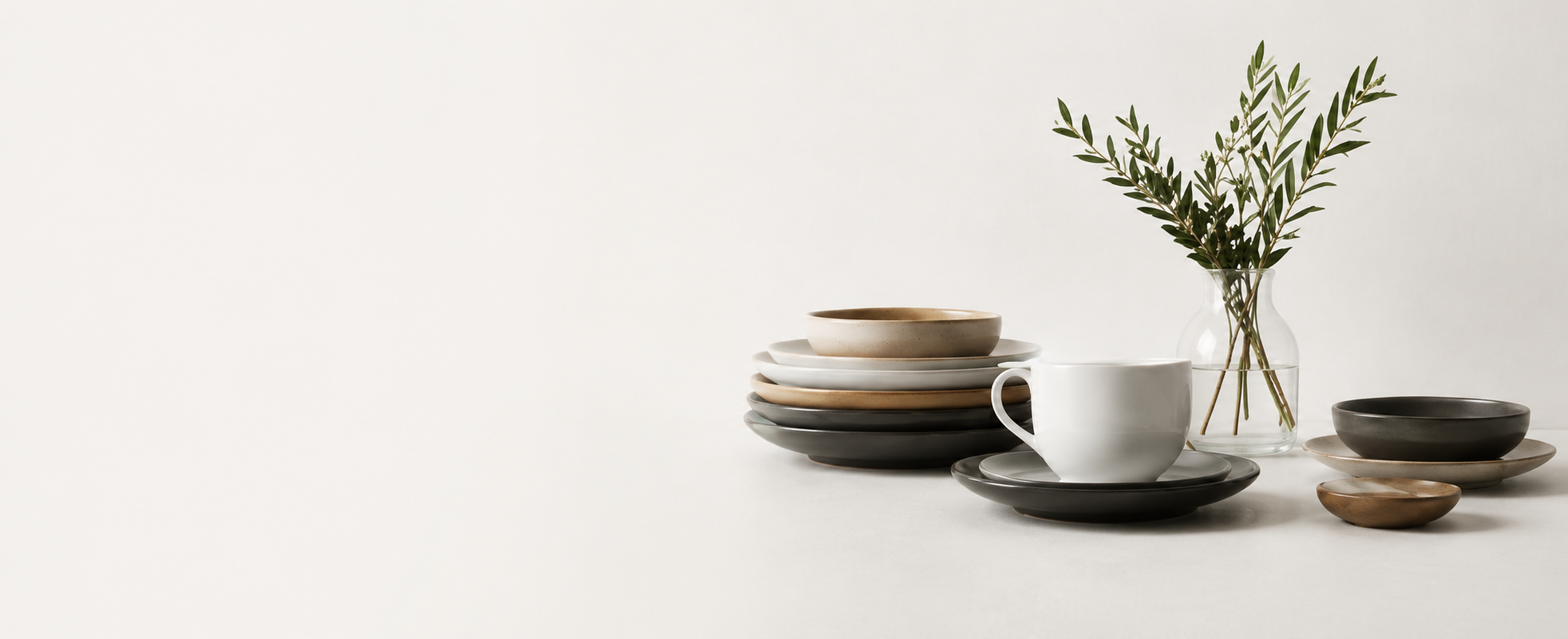 Minimalist customer support banner featuring elegant ceramic tableware, a white coffee cup, and a glass vase with green branches on a soft neutral background alongside “We’re Here to Help” support message text in a clean modern layout.