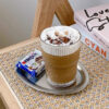 KJ073A-clear-textured-drinking-glass-cup Clear ribbed glass tumbler serving coffee beverage in modern café table setting